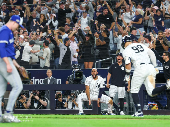 New York City baseball players and fans celebrating a key play in the vibrant NYC sports scene atmosphere.