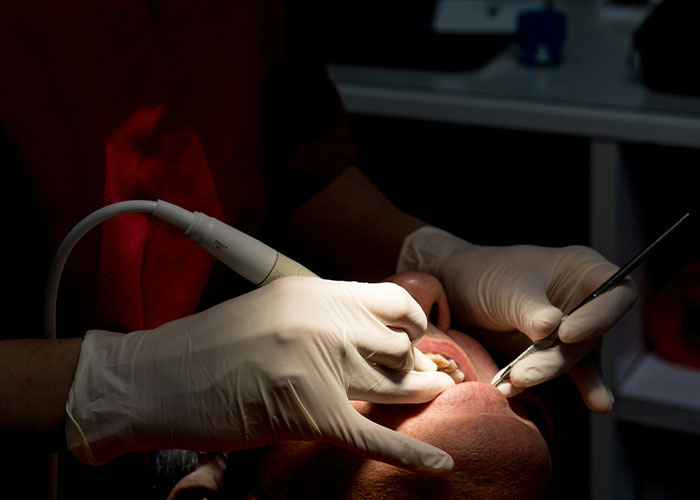 Patient in dentist chair receiving a dental procedure, highlighting a haunting final moment before a fatal outcome. Patient in dentist chair receiving a dental procedure, highlighting a haunting final moment before a fatal outcome.