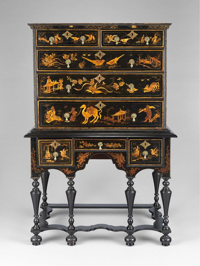 Antique cabinet with detailed cultural artwork capturing emotion and everyday life in old craftsmanship.
