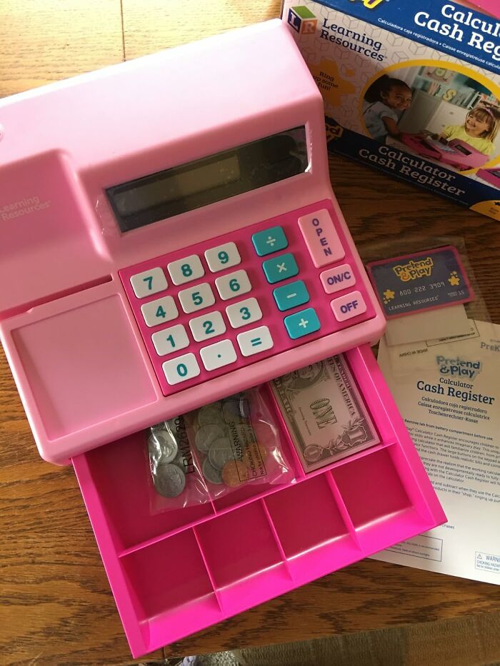 Pink toy calculator cash register with play money and box, a gift that brings 5-year-old joy and imaginative play.