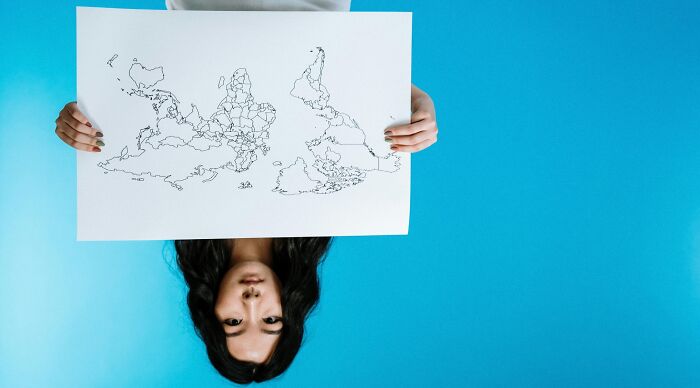 Person holding a rotated map featuring outlines of 28 countries, challenging geography nerds to guess each one. Person holding a rotated map featuring outlines of 28 countries, challenging geography nerds to guess each one.