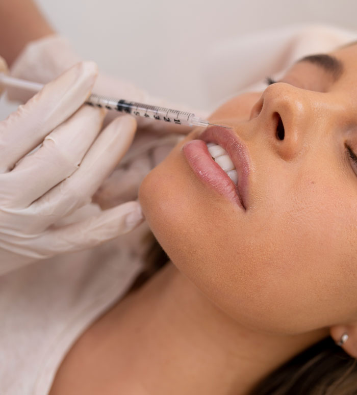 A woman receiving a lip injection, illustrating cosmetic procedures women do to seem attractive that men find off-putting.