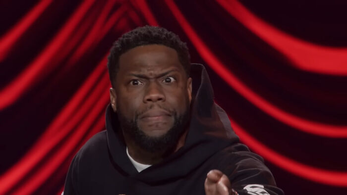 Comedian performing on stage with intense expression, highlighting people think celebrities closet skeletons concept.