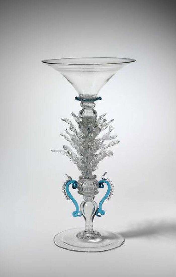 Intricately designed old glass chalice showcasing craftsmanship and culture from the past in a powerful historic photo.