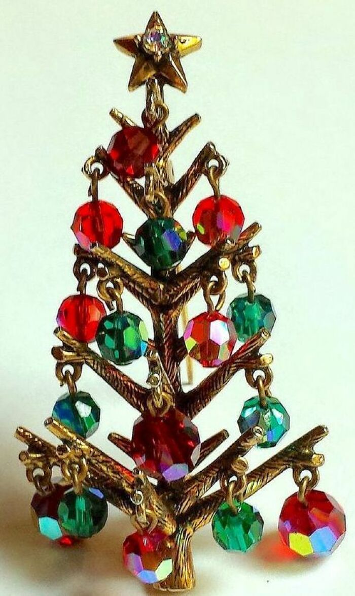 Vintage Christmas tree brooch with colorful red and green beads reflecting emotion and culture in powerful old photos.