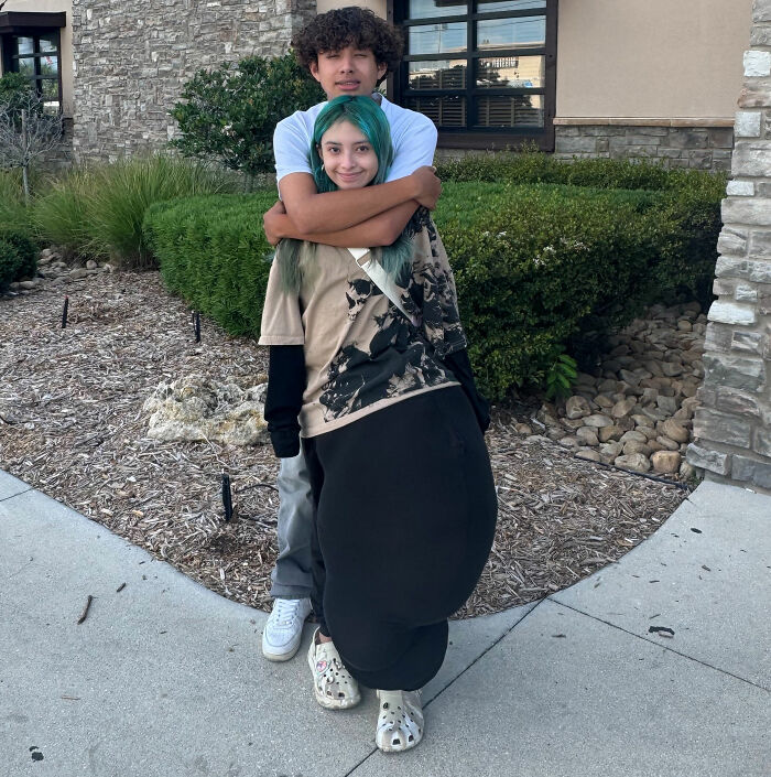 14YO girl with rare condition standing outside with a companion, showing leg affected by a rare medical condition.