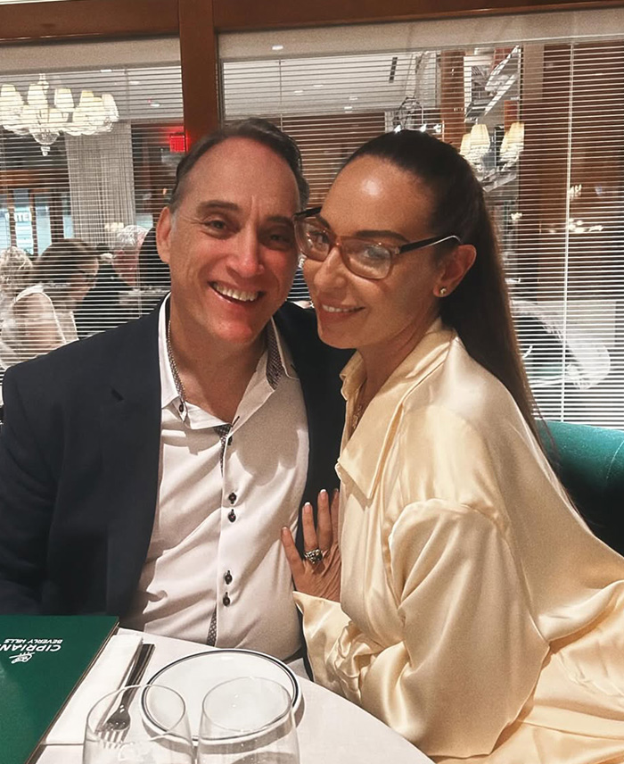 Pareja sonriente en restaurante, relacionada con pasajera de Air Canada que critica comida caducada y disputa con aerol&iacute;nea.