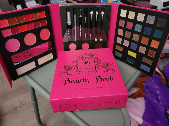 Beauty Book makeup set with eyeshadows, lipsticks, and brushes, featured in blind boxes for Christmas surprise gifts.