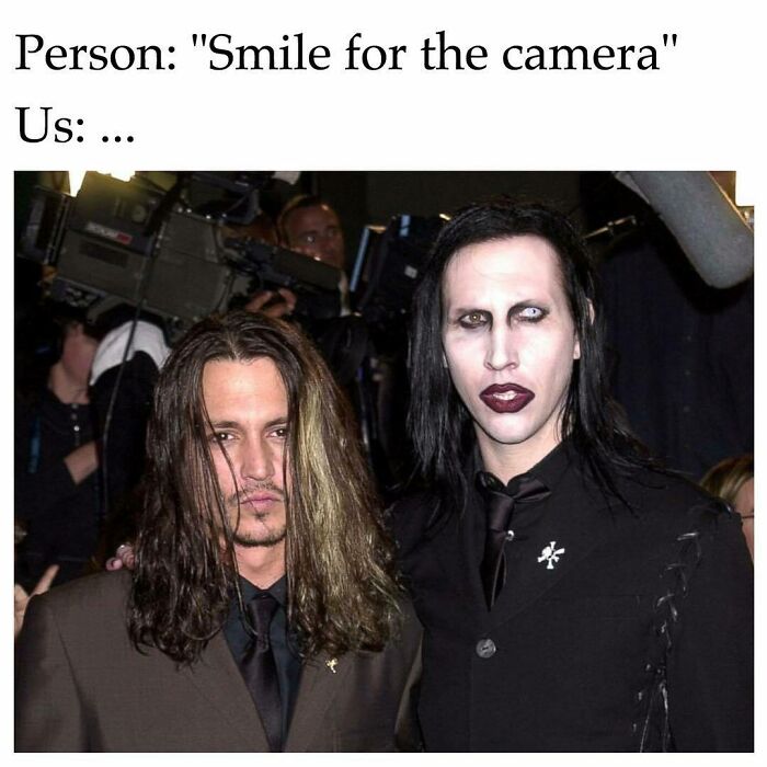 Two men posing seriously for the camera with goth makeup and dark clothing, illustrating goth memes humor.