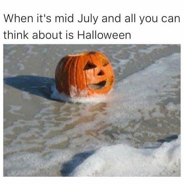 Pumpkin on the beach in mid-July with waves, capturing goth memes humor about thinking of Halloween early.