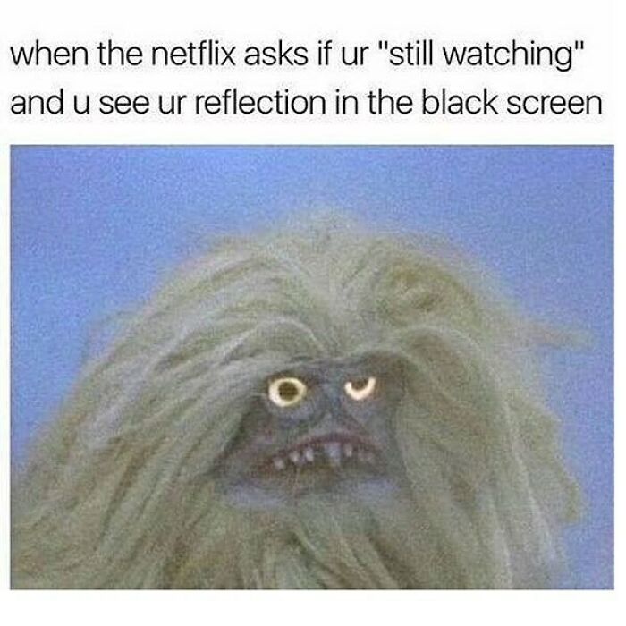 Meme of a disheveled creature reacting to seeing its reflection on a black screen, fitting goth memes theme.