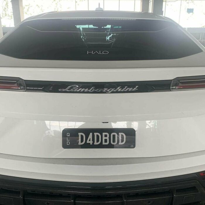 White Lamborghini with a hilarious personalized license plate D4DBOD, capturing attention for its clever custom design.