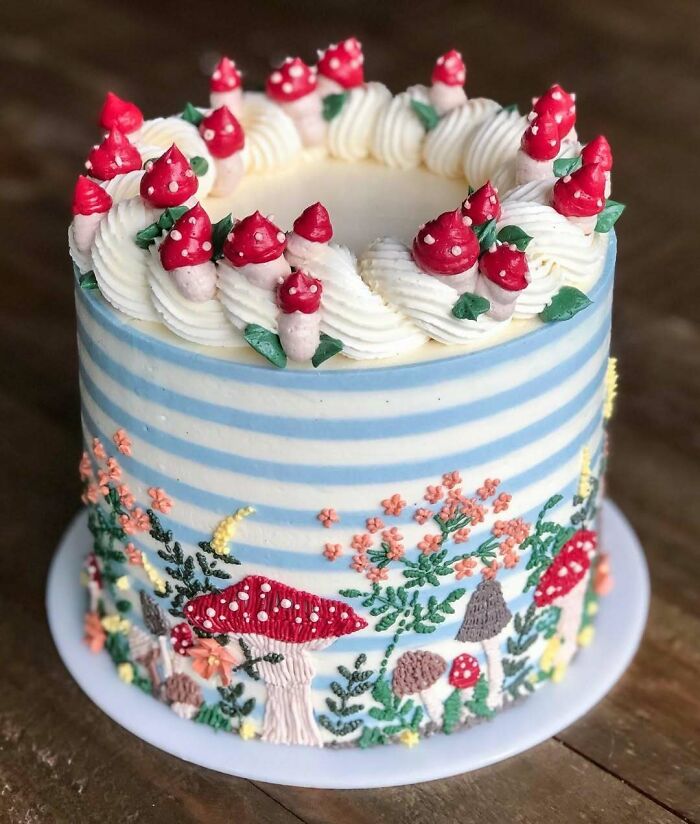 Decorative cake with masterfully crafted mushroom and floral designs showcasing creativity in cake decoration.