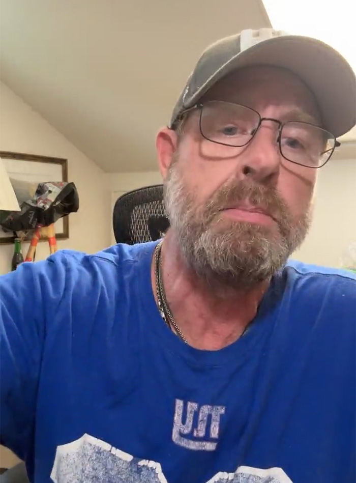 Man with glasses and cap in home office setting, looking serious, related to ChatGPT accused of turning son against mother.