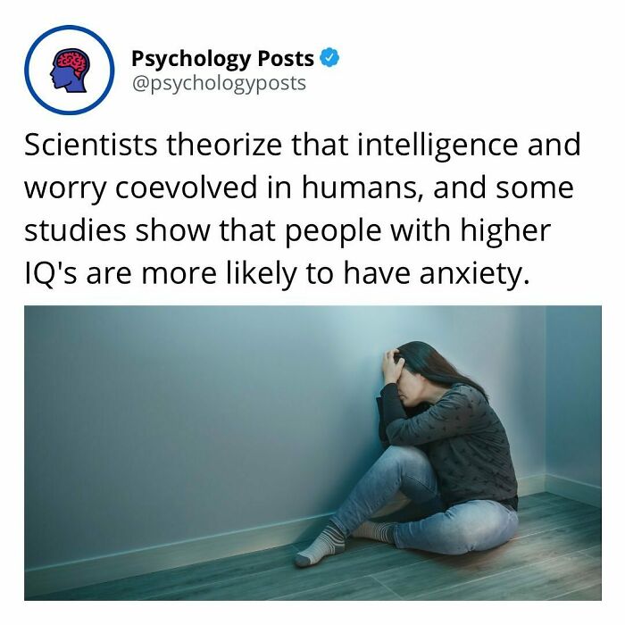 Tweet from Psychology Posts about intelligence, anxiety, and worry, with image of a distressed person sitting on the floor indoors.
