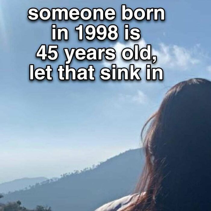 Person looking at a mountain landscape with funny unhinged memes text about birth year and age for grapejuiceboys content.