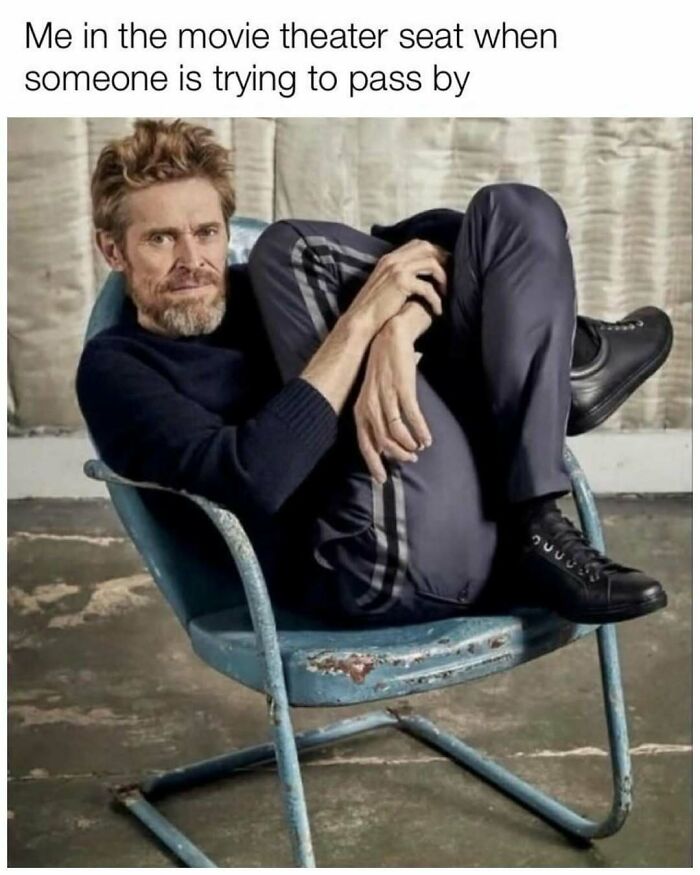 Man curled up awkwardly in a metal chair illustrating a funny random meme perfect to scroll when you’re in a slump.