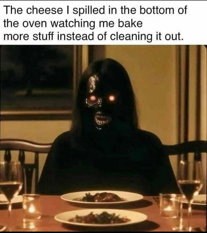 Dark figure with glowing eyes sitting at a table, representing humor in handling reality with memes about spilled cheese.