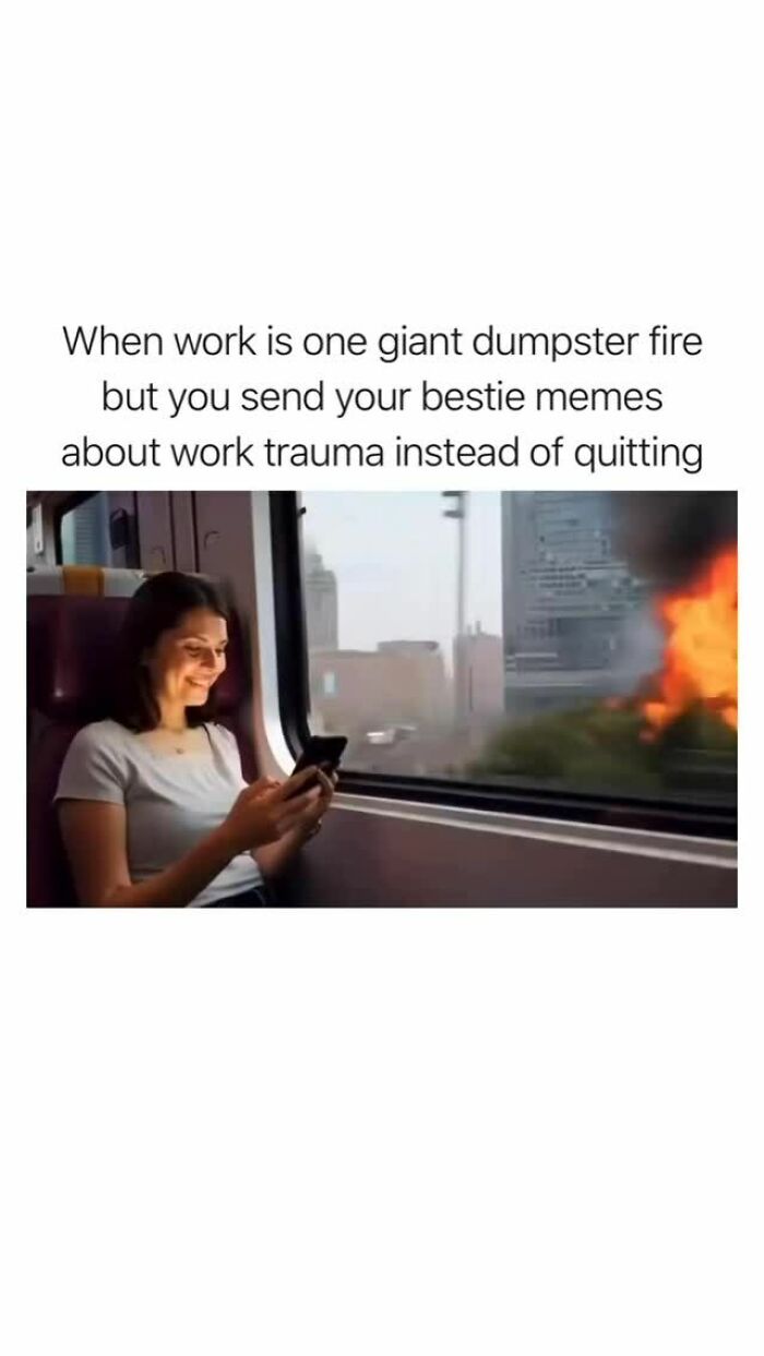 Woman smiling at phone on train as fire blazes outside window, illustrating funny random memes about work trauma coping.