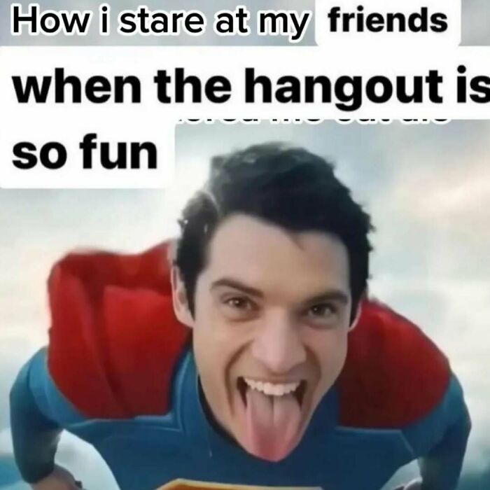 A man dressed as Superman making a funny face with tongue out in a humorous meme about friends and hangouts.
