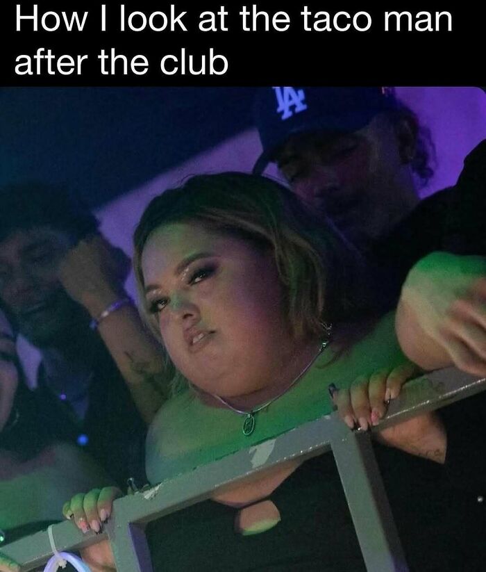 Woman with intense expression leaning on railing at a club, illustrating humor and reality through memes.