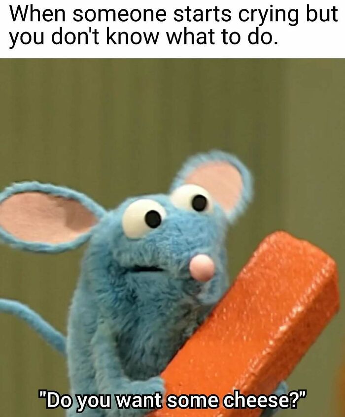 Blue puppet mouse holding a brick, caption humorously handling reality with humor in an awkward moment.
