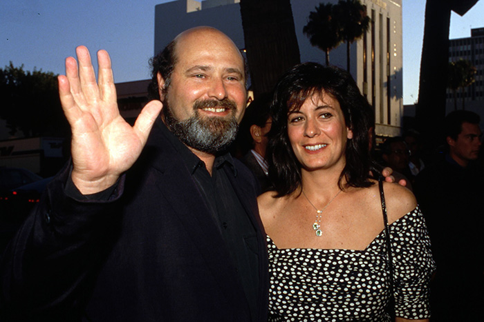 Rob Reiner with a woman at an outdoor event, showcasing Hollywood icon discussions and close friendship moments.