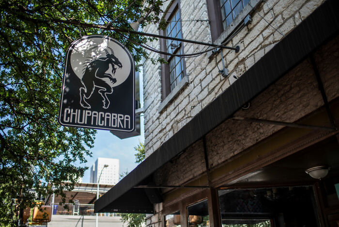 Street sign featuring a creature silhouette representing urban legends that could be chillingly real in a city setting.