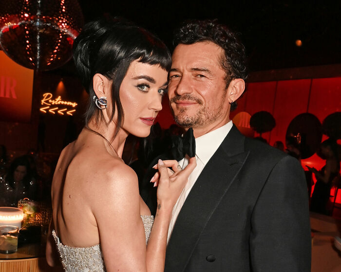 Katy Perry and Justin Trudeau dressed elegantly during a meeting with Japan's ex-prime minister in a formal setting. Katy Perry and Justin Trudeau dressed elegantly during a meeting with Japan's ex-prime minister in a formal setting.