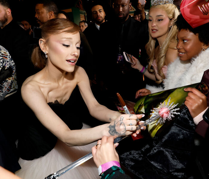 Ariana Grande interacting with fans, highlighting Ariana Grande family member breaking silence on struggles.