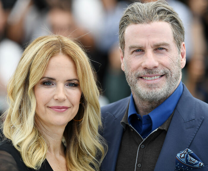 Riley Keough and John Travolta posing together at an event, related to court docs and biological mother claims.