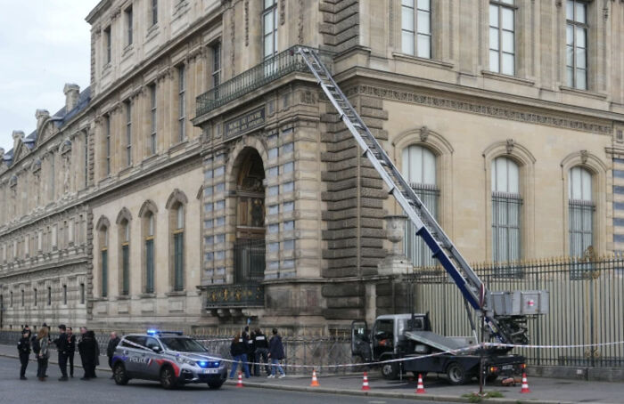 Police and emergency responders with a ladder truck outside a large historic building in 2025 defining moment.