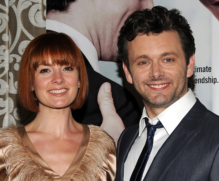 Michael Sheen smiling with a woman at an event, highlighting his dating history that stuns fans.