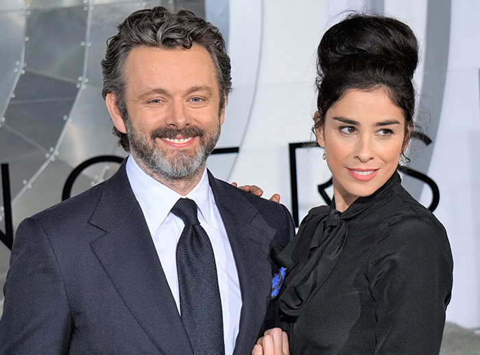 Michael Sheen smiling with a woman at a formal event, highlighting Michael Sheen dating history details.