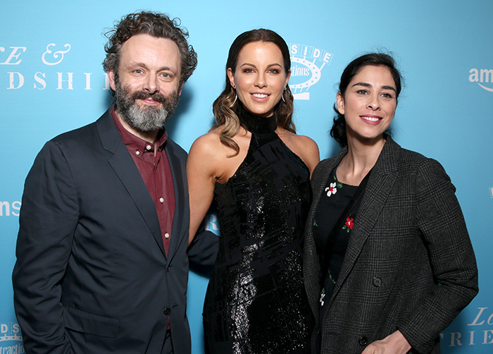 Michael Sheen posing with two women at an event, spotlighting Michael Sheen's dating history that stuns fans.