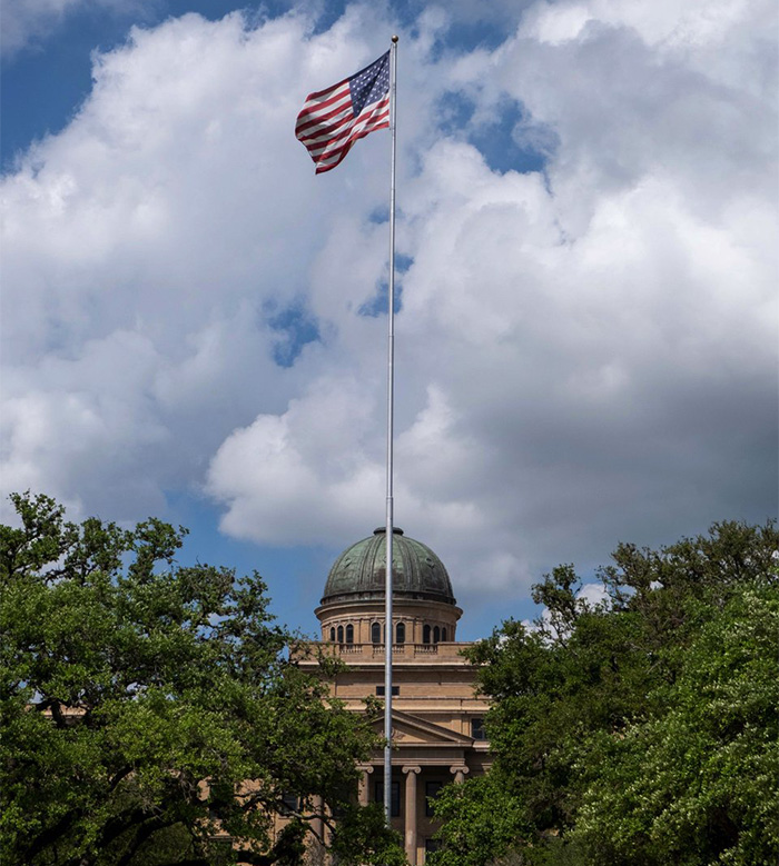 American flag flying above government building symbolizing mom of late cheerleader challenging cops' ruling after phone clue discovery