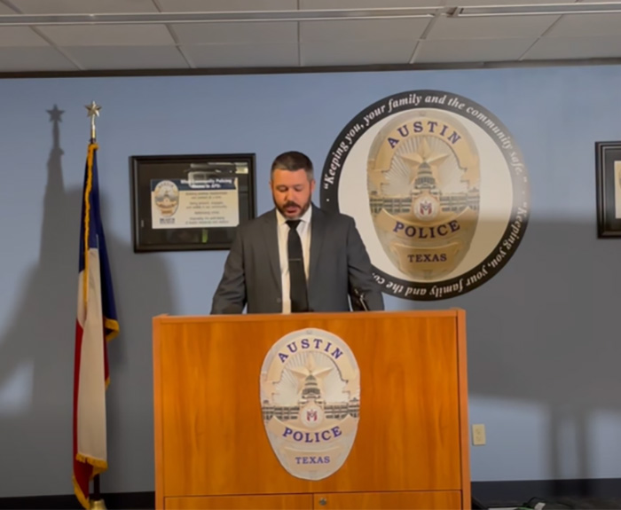 Austin police officer at podium during press briefing on crucial clue found on late cheerleader&rsquo;s phone.