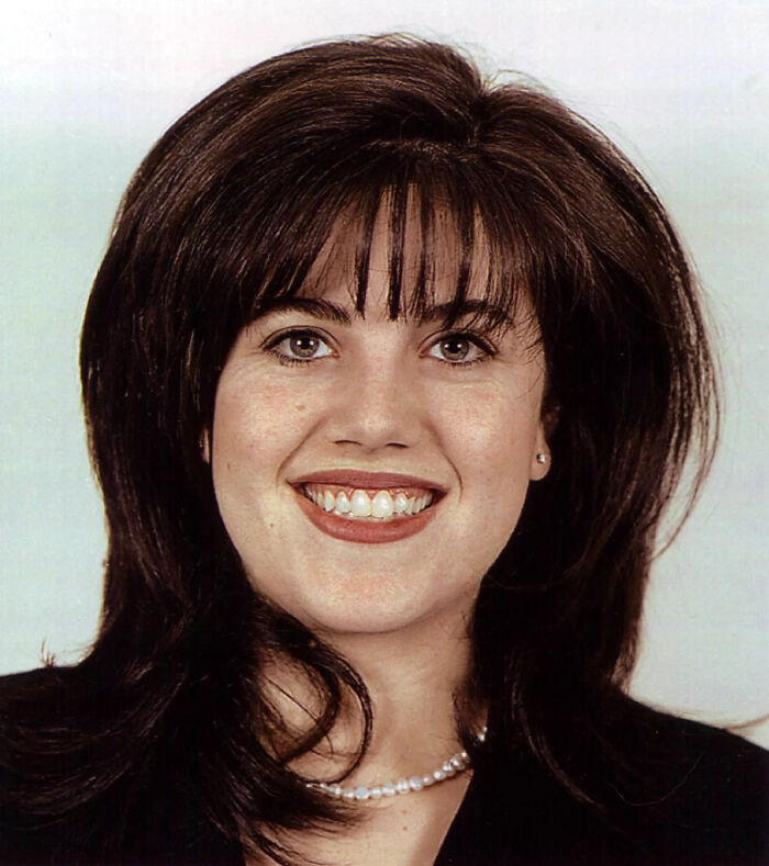 Young woman with dark hair and pearl necklace smiling, representing cancel culture victims among celebrities.