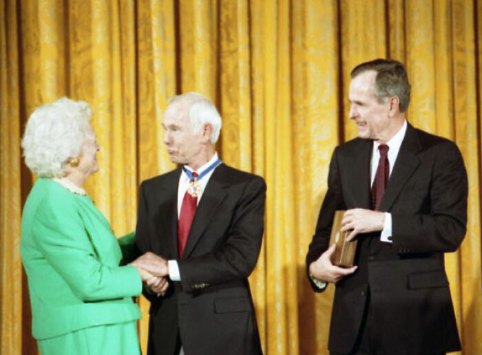 Three formally dressed people at an award ceremony, related to banned stars from the Tonight Show by Johnny Carson.