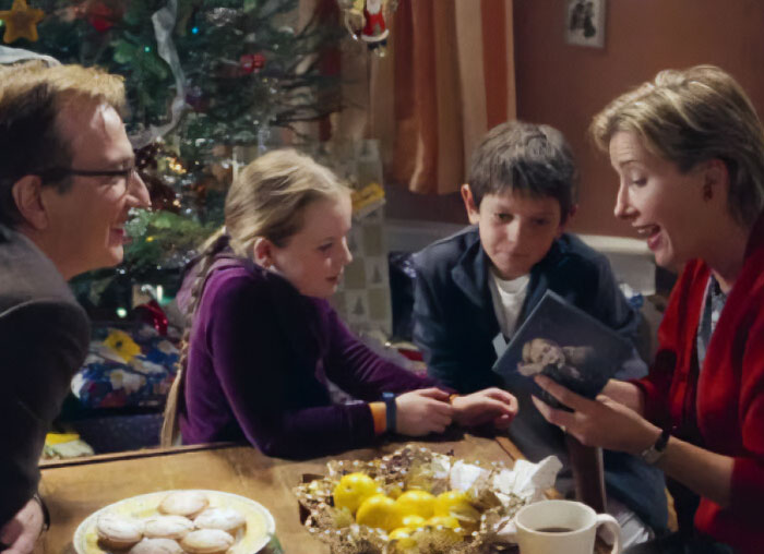 Family gathered around a table during Christmas, relating to Timothée Chalamet Love Actually misread reactions. Family gathered around a table during Christmas, relating to Timothée Chalamet Love Actually misread reactions.