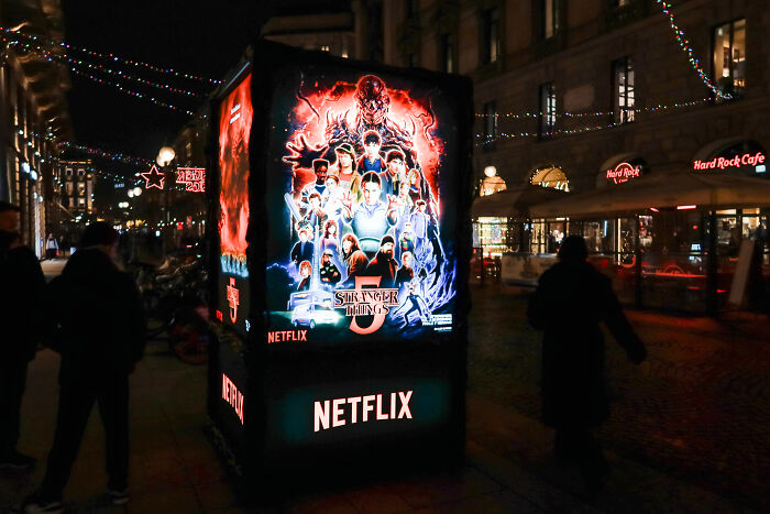 Stranger Things promotional display at night as fans expose major episode blunder, prompting rush to edit the series.