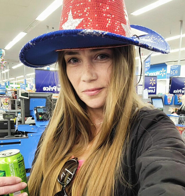 Woman wearing a red and blue sequined hat inside a store, related to Cinnabon worker's daughter and racist tirade.