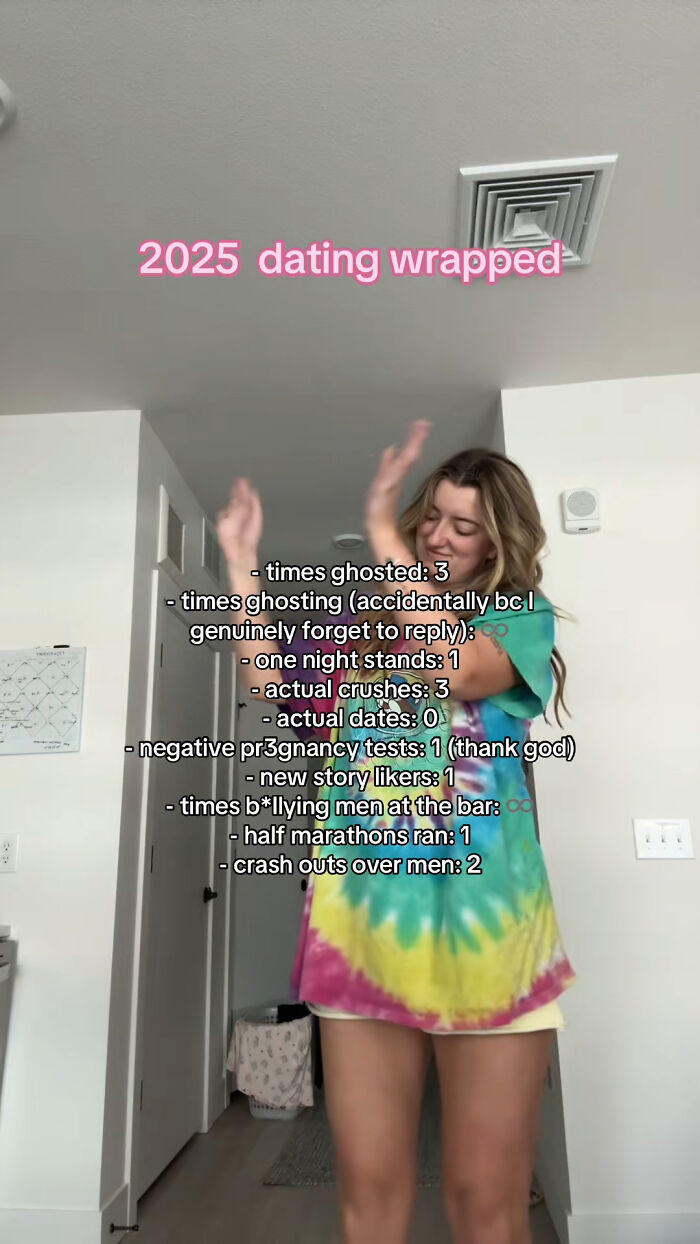 Young woman in a tie-dye dress dancing indoors with 2025 dating statistics reflecting how the year backfired for her.