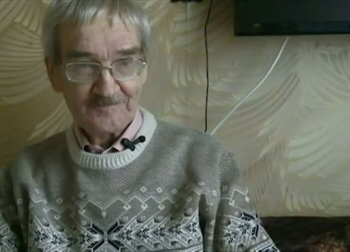 Elderly man wearing glasses and a patterned sweater in a cozy indoor setting, illustrating life facts that might surprise.