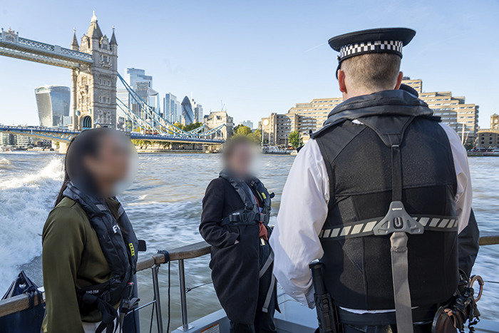 Police officers on a boat near Tower Bridge investigating behavior of a wealthy US student after altercation incident