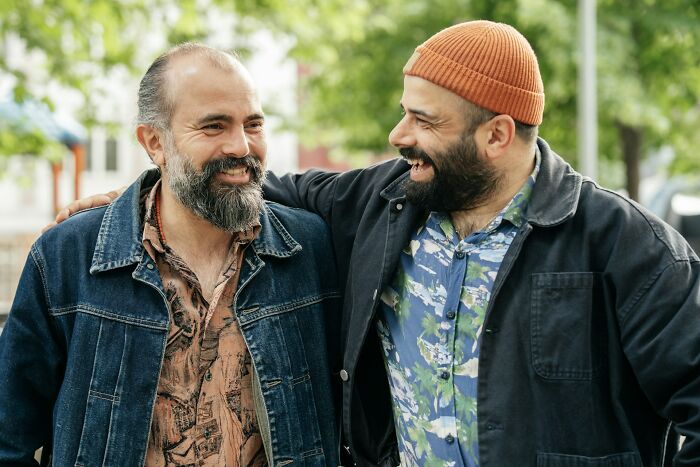 Two men smiling and embracing outdoors, illustrating true stories that sound made up but actually happened.