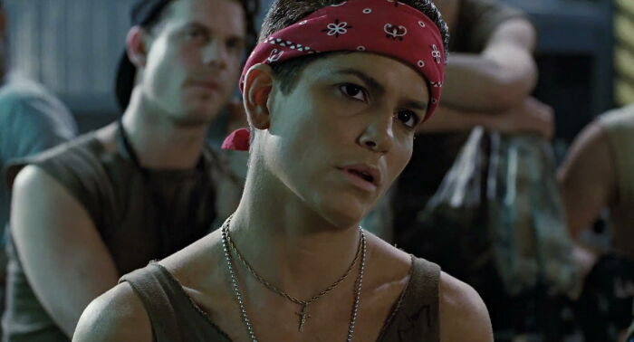 Young person wearing a red bandana and tank top among a group, symbolizing stories of once famous regular job lives.