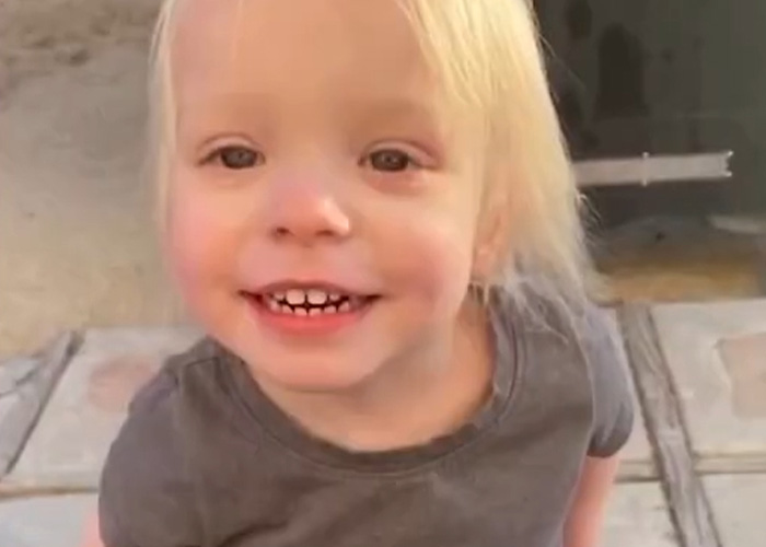 Young blonde toddler smiling outdoors, related to mom's chilling Google searches in case of 5-year-old daughter's slaying.