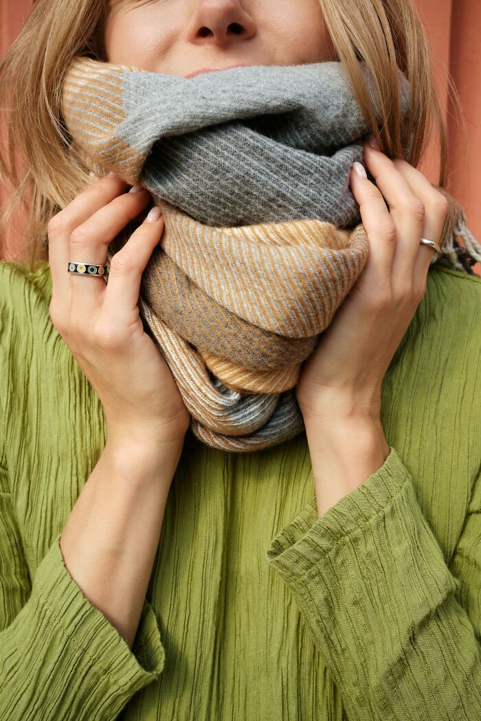 Woman wearing an unusual personal belonging, a multicolored scarf, lost and found item wrapped around her neck