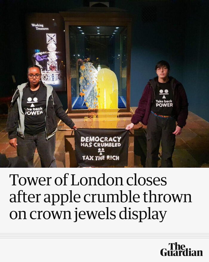 Two protestors hold a banner inside Tower of London after apple crumble thrown at crown jewels in local newspaper headlines.
